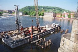 Impact driving of oak piles into pre-drilled holes carried out with use of continuous auger; reconstruction of ice-breakers at the Charles Bridge in Prague