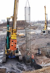 Installing a reinforcement cage into the cased hole