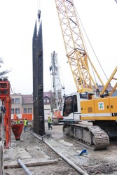 Fitting a reinforcement cage into an excavated trench prior to diaphragm wall panel concreting