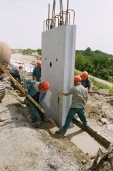 Embedding and adjustment of a prefabricated wall panel into a trench filled with a self-hardening suspension - the Radial road in Prague-Vysočany