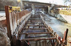 A strutted cofferdam made of sheet piles fitted into pre-excavated trenches filled with clay-cement mixtures. An elevated road cantilevered over the Bílina River in Ústí nad Labem